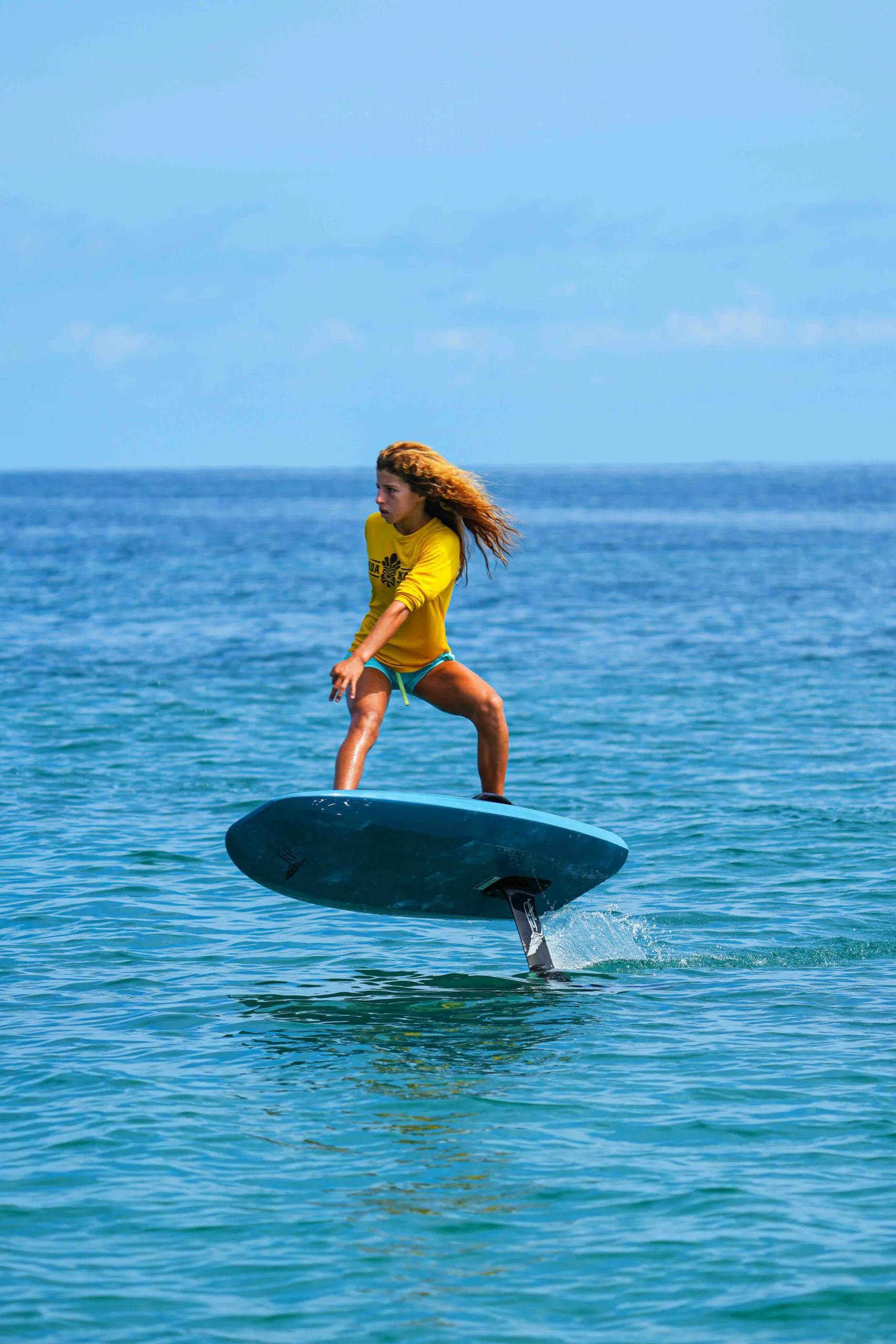 Professional e-foil instructor guiding lesson on the ocean